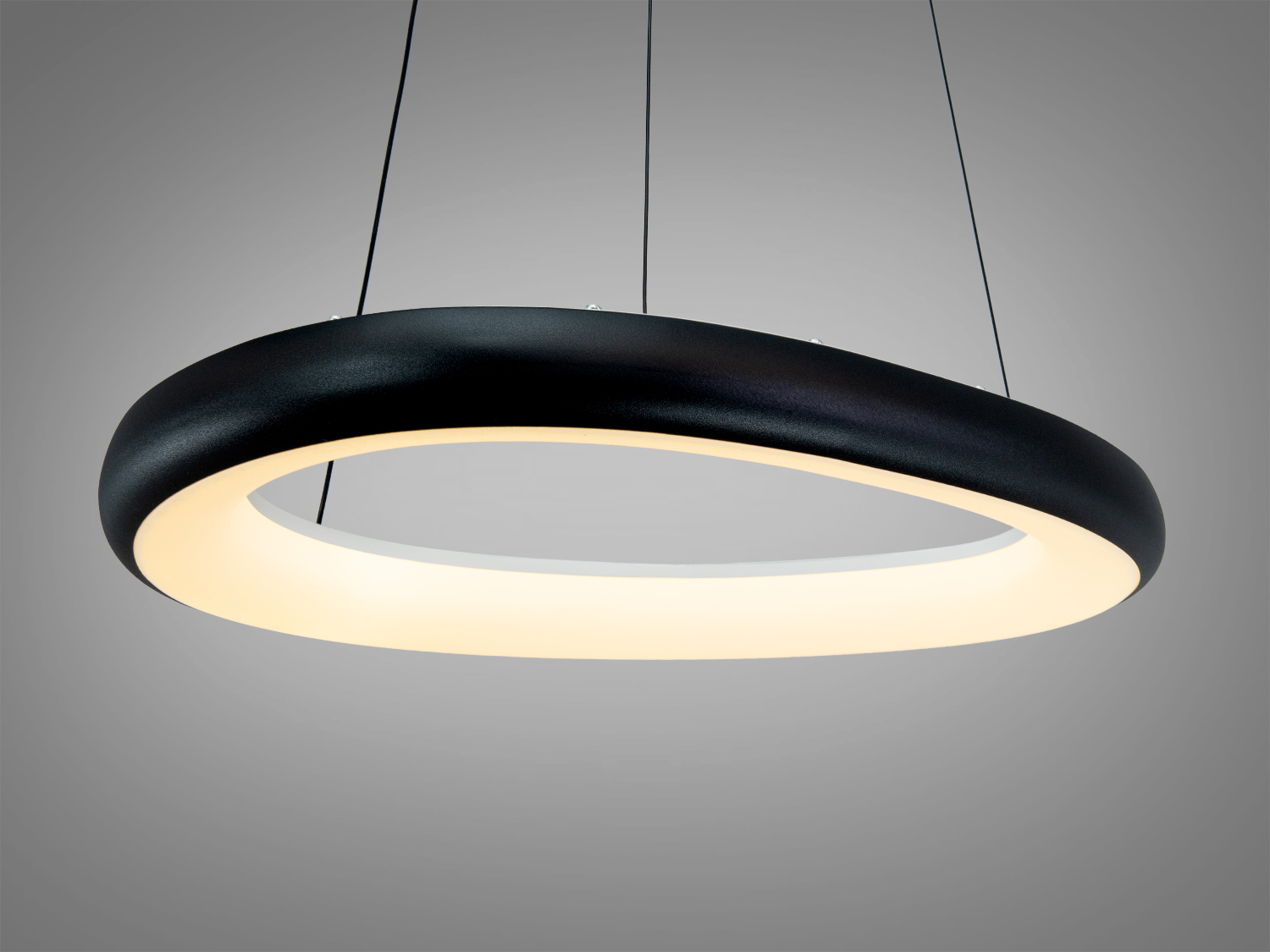 Світильник з круглою формою та теплим світлом, підвішений на тросах. Чорний корпус додає елегантності.