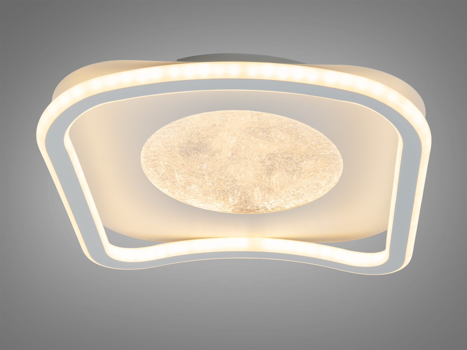 Світильник з плавними лініями та центральним елементом, що нагадує крижаний диск. Підходить для офісних приміщень.