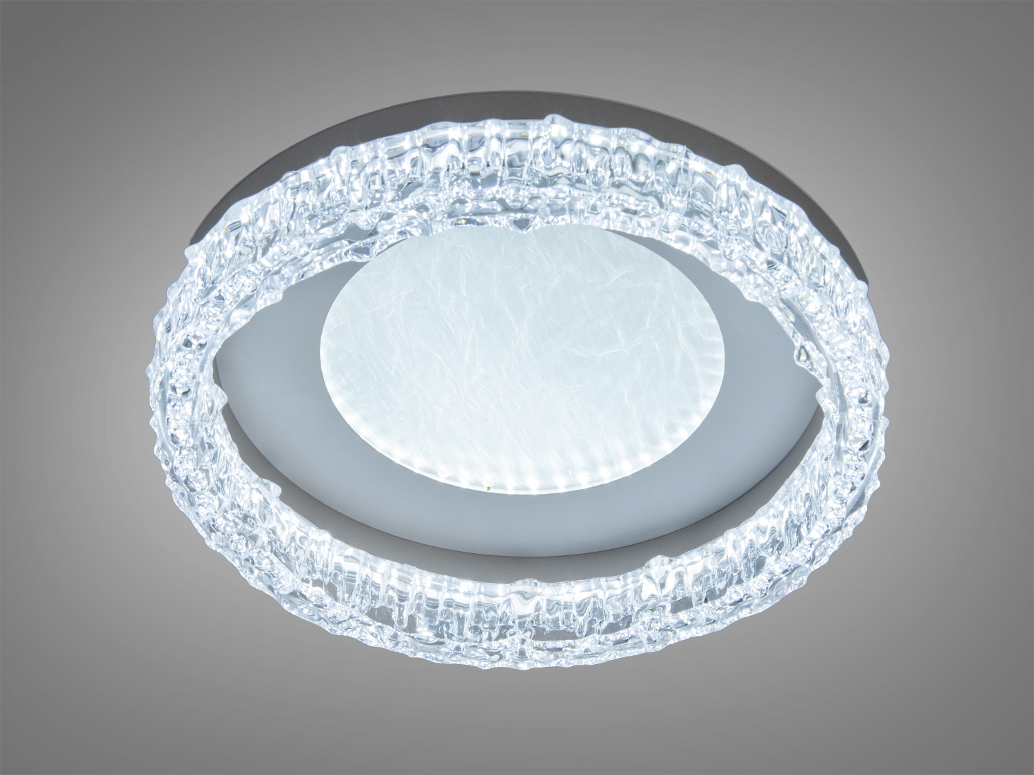 Кругла стельова світлодіодна лампа з прозорим декоративним обідком, що нагадує лід. Підходить для сучасних інтер′єрів.