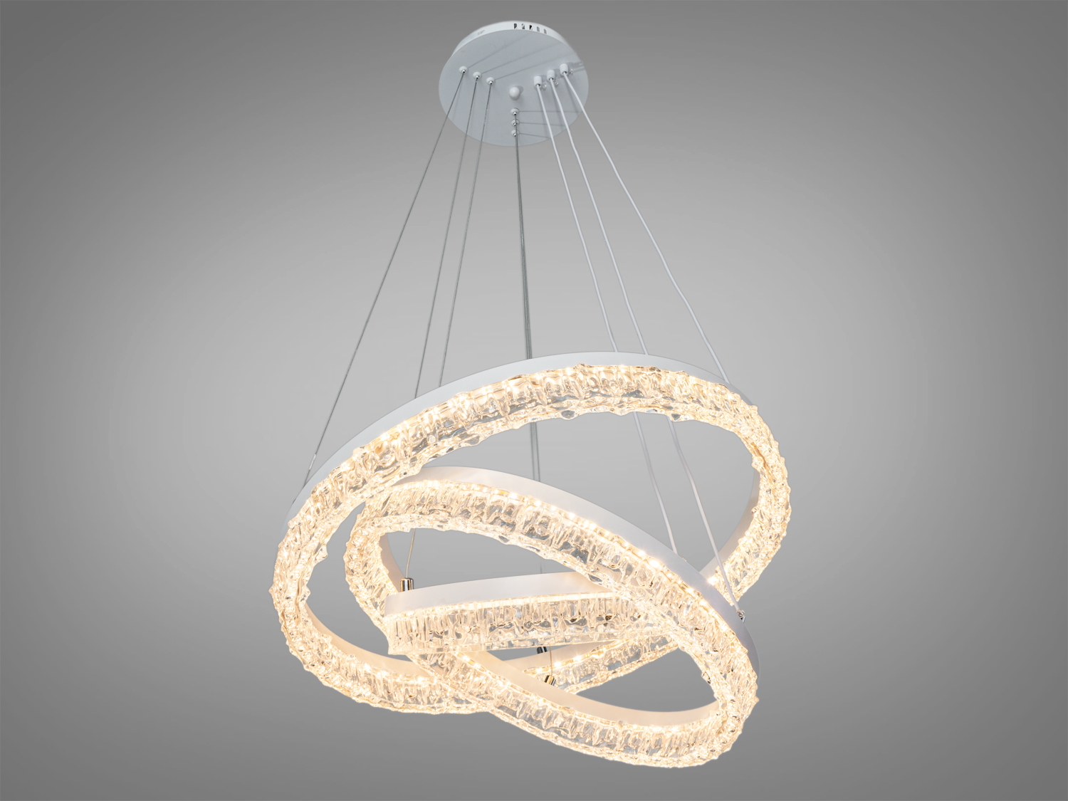 Світильник з теплим світлом, що випромінюється трьома переплетеними акриловими кільцями. Ідеальний для затишних житлових приміщень.