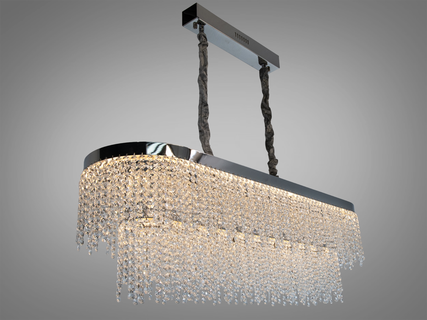 Елегантна люстра з хромованою основою та каскадом кришталевих підвісок, що підходить для освітлення великих приміщень.