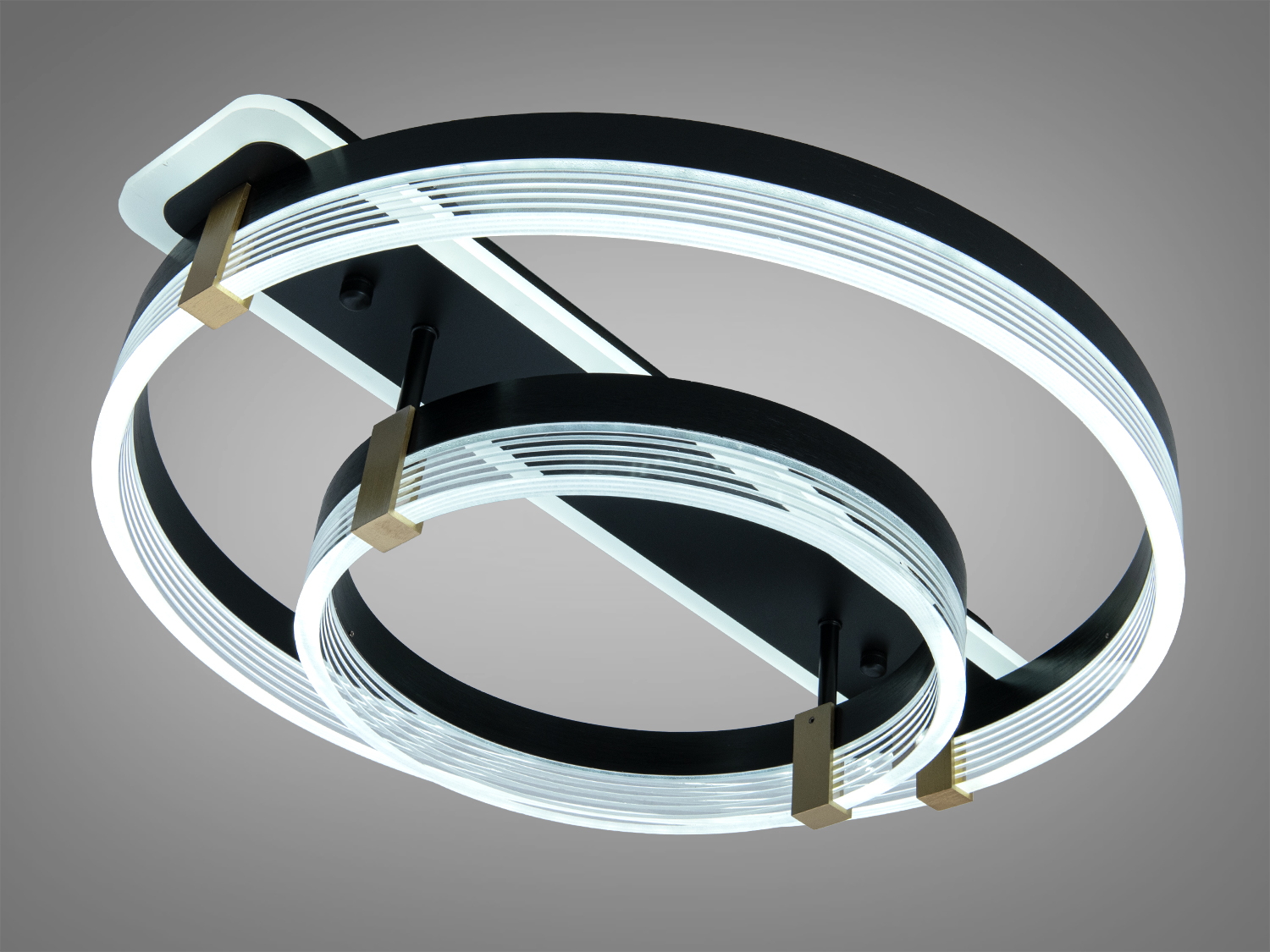 Світильник з двома кільцями, виготовлений з металу, підходить для монтажу на стелі в офісних приміщеннях.