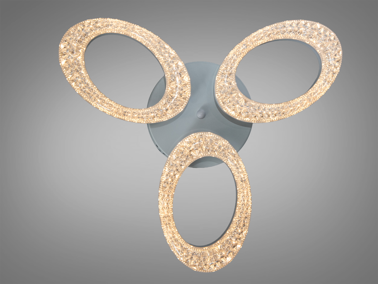 Світильник з трьома кільцями, виготовлений з прозорого матеріалу. Підходить для використання у великих приміщеннях.