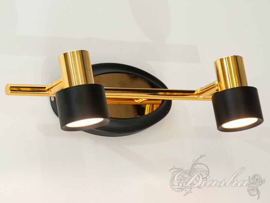 Двосвітильник із золотистою основою та чорними плафонами. Випромінює тепле світло, ідеальний для вітальні.