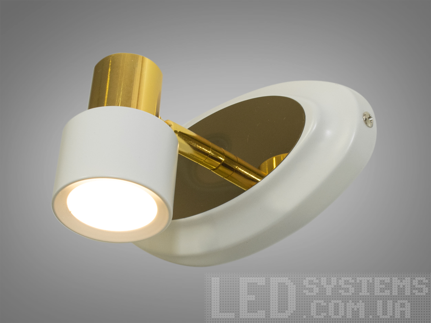 Настінний світильник із білим корпусом та золотистим елементом, що обертається. Підходить для акцентного освітлення.