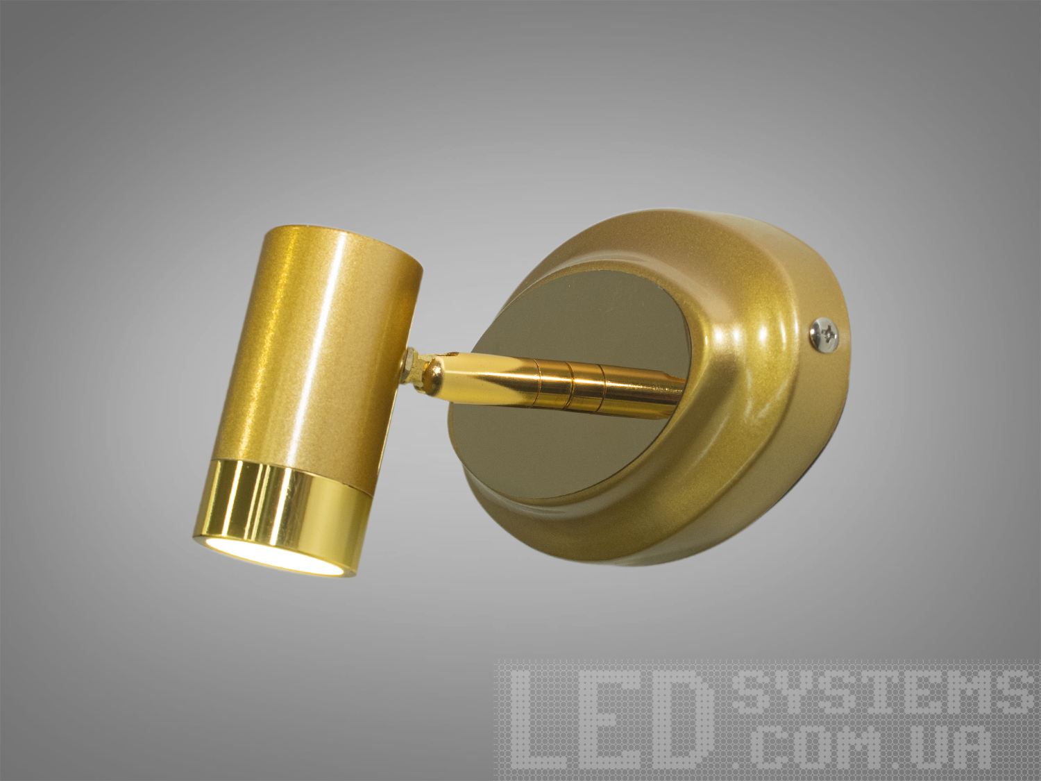 Настінний світильник золотистого кольору з циліндричним корпусом, підходить для акцентного освітлення.