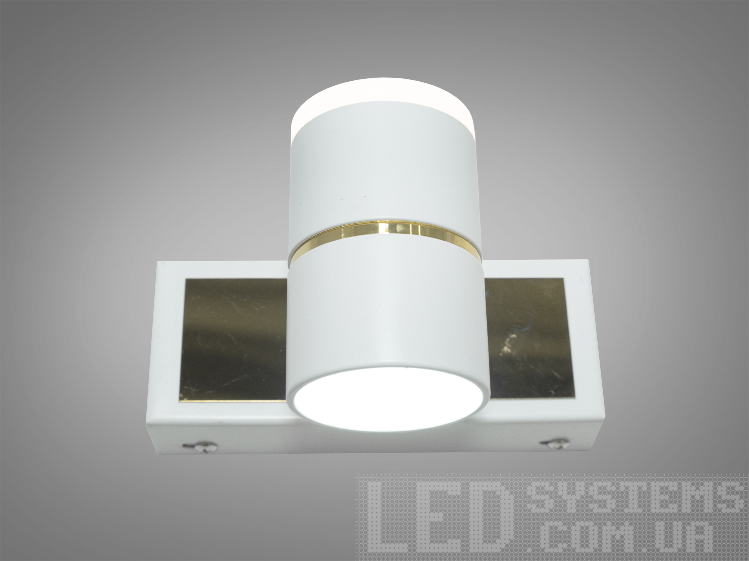 Світлодіодний світильник з білим циліндричним корпусом і золотистим акцентом, призначений для настінного монтажу в сучасних приміщеннях.