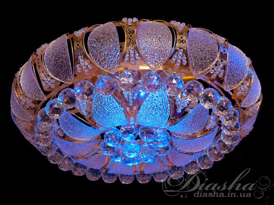 Цілком нові ексклюзивні кришталеві люстри, представлені на нашому сайті, можуть підкорити своїм блиском і пишністю навіть найвимогливіших покупців. Ми із задоволенням представляємо Вам колекцію кришталевих стельових люстр під звичайну лампу розжарювання, світлодіодну лампу або економку, здатну ідеально підходити для кімнат з висотою стель всього від 2,3 метрів. Тепер непередаваний блиск високоякісного кришталю осяє квартири простих українців.
Кришталева стельова люстра виконана під лампочку з цоколем Е14. Тепер світлодіодне підсвічування з самою багатою гамою кольорів і різноманітністю режимів LED підсвічування - в ній Ви побачите всі кольори веселки. Світлодіодне підсвічування на основі поєднання спектрально чистих світлодіодів плавно переливається в підвісках з високоякісного кришталю, наповнюючи Вашу кімнату чудовими різнокольоровими відблисками кришталю. Управління режимами люстри здійснюється з пульта дистанційного керування.&nbsp;