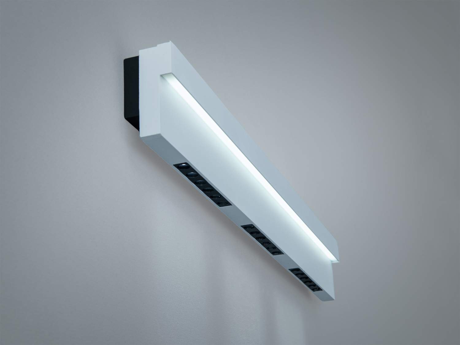 Настінний світильник з білим корпусом, оснащений світлодіодами, забезпечує рівномірне освітлення.