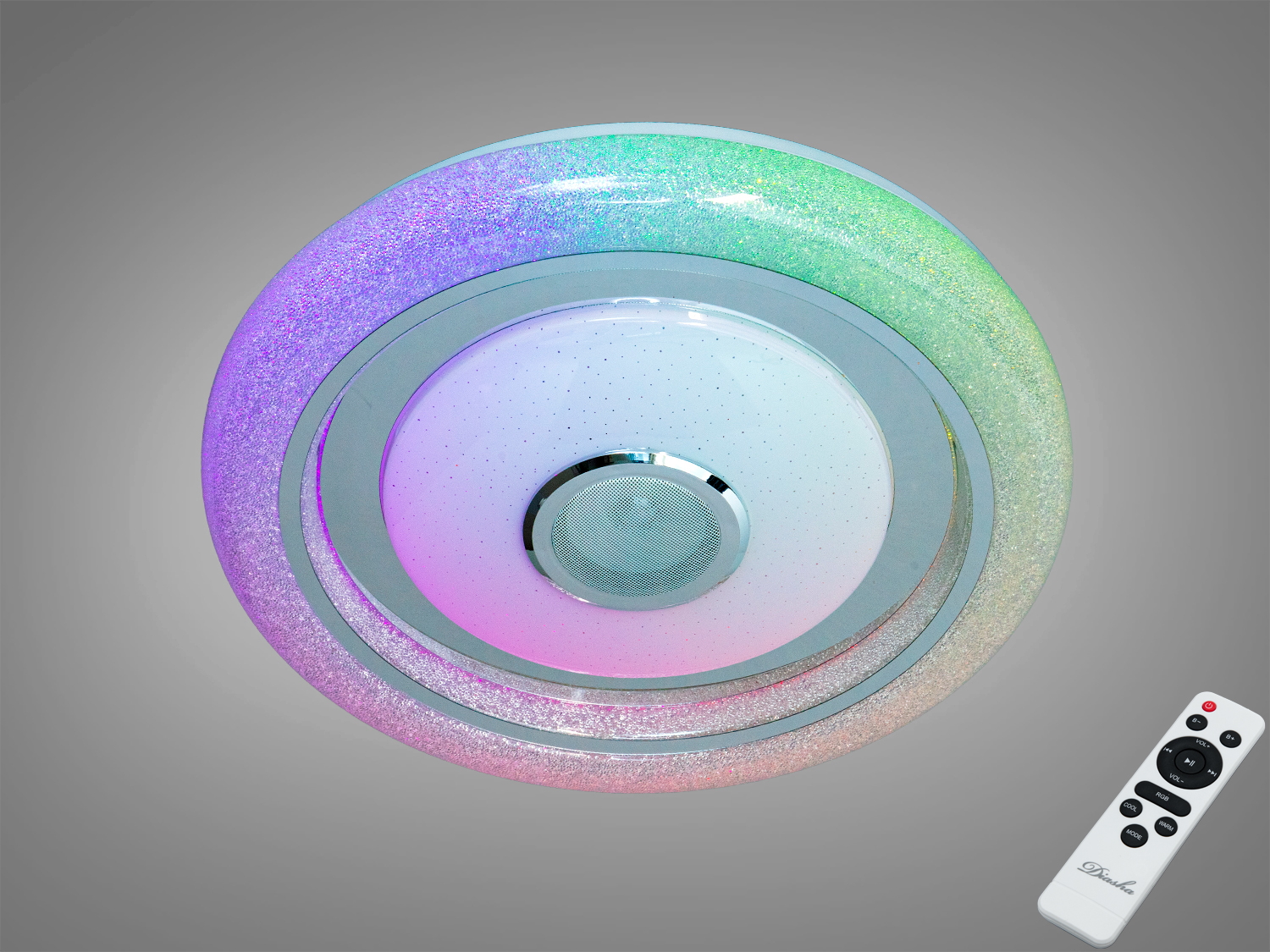 Круглий стельовий світильник із рожевим відтінком та вбудованим динаміком. Оснащений дистанційним керуванням для зручності використання.