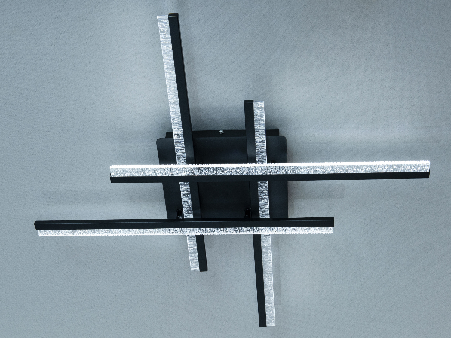 Світильник з чорними планками, що перетинаються, з матовою поверхнею. Підходить для монтажу в кімнатах з низькими стелями.