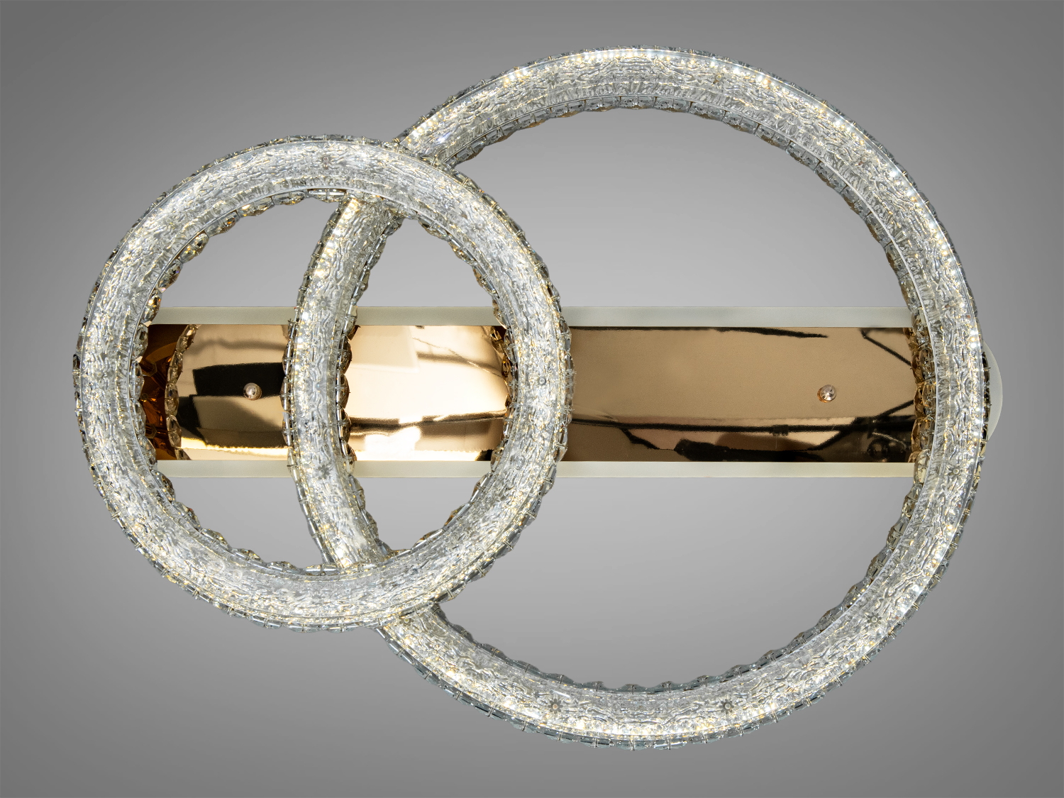 Світильник з двома акриловими кільцями на золотистій основі, що підходить для сучасного інтер′єру. 