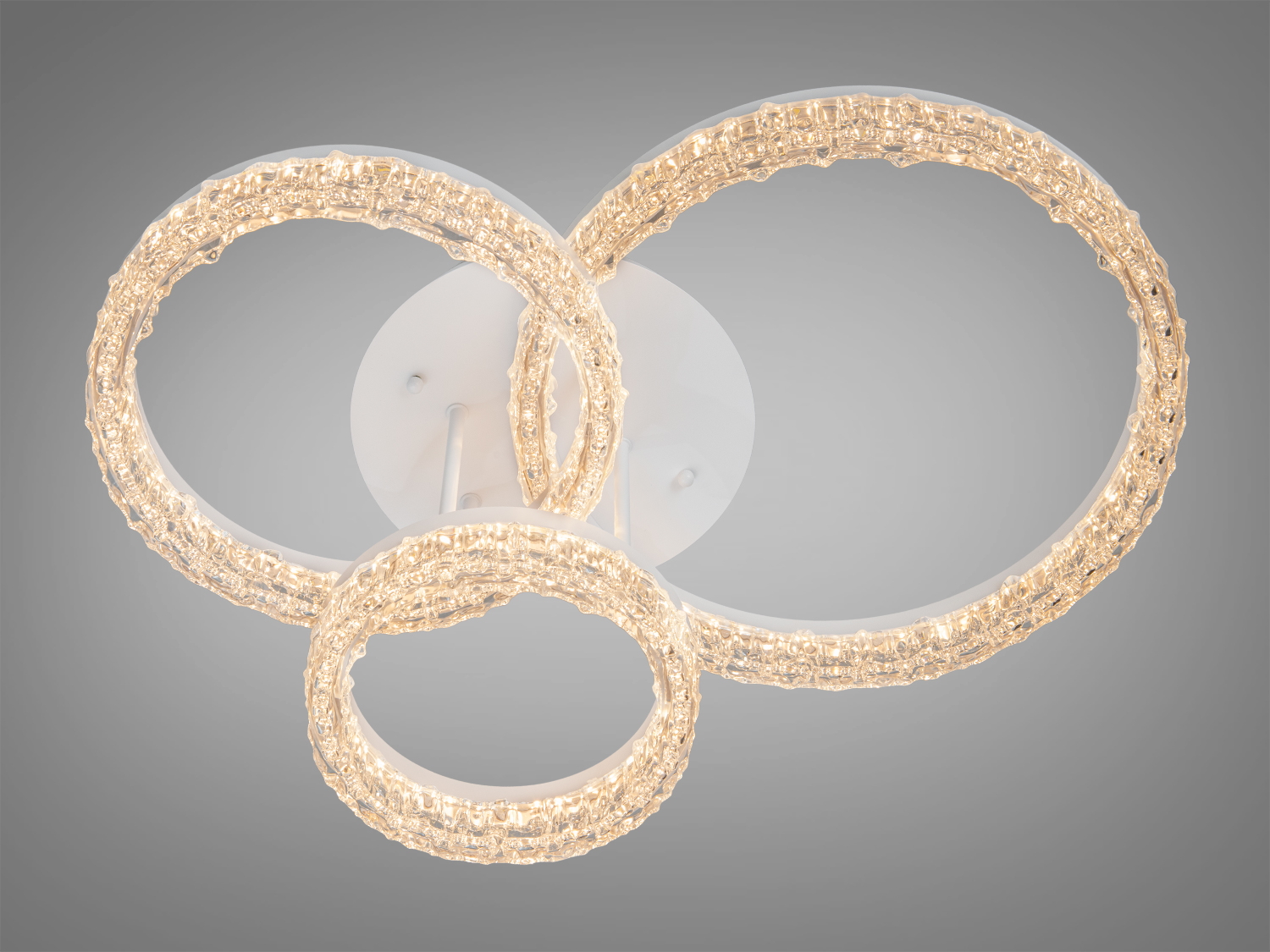 Стельовий світильник з трьома кільцями, що випромінюють м′яке світло, має матову поверхню для рівномірного освітлення.