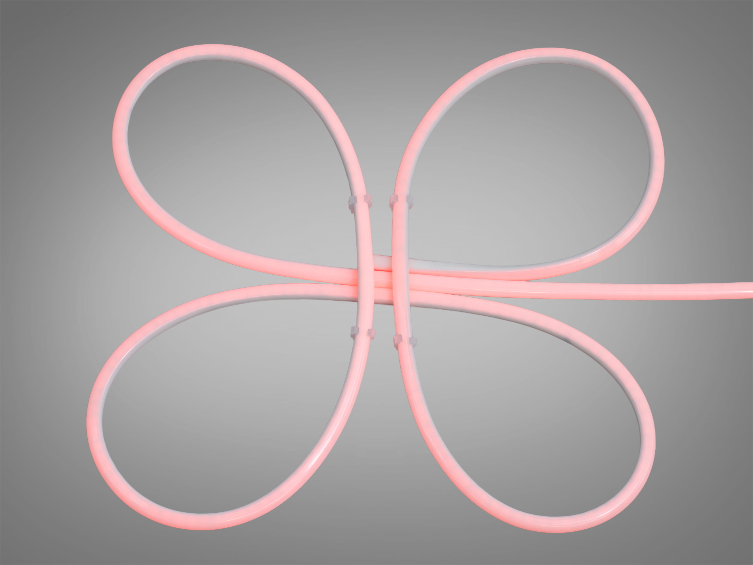 Неоновий шнур рожевого кольору у формі петель. Підходить для створення декоративних елементів у просторі.