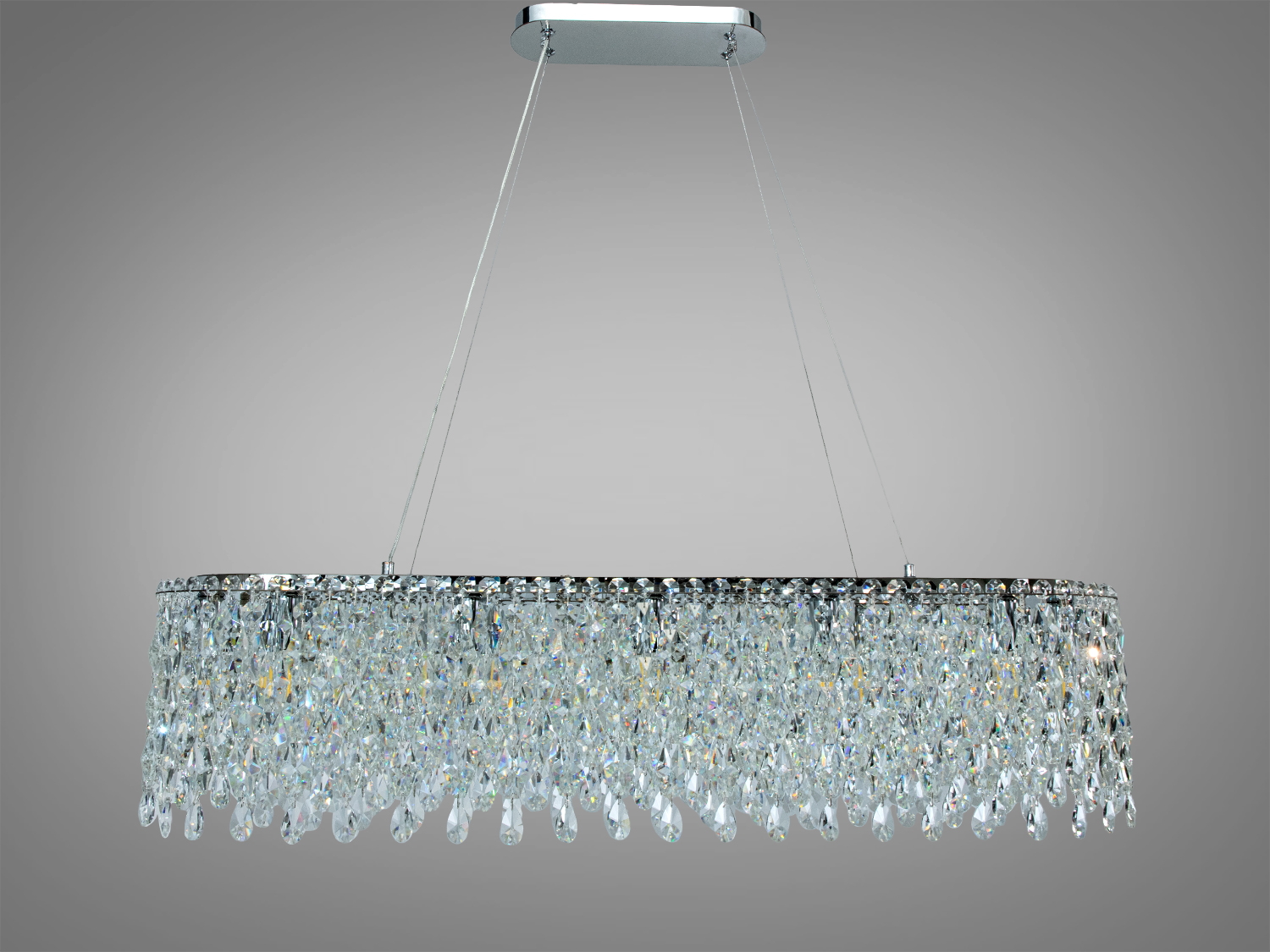 Овальна люстра з блискучими кришталевими елементами, підвішена на тонких тросах. Підходить для високих стель.
