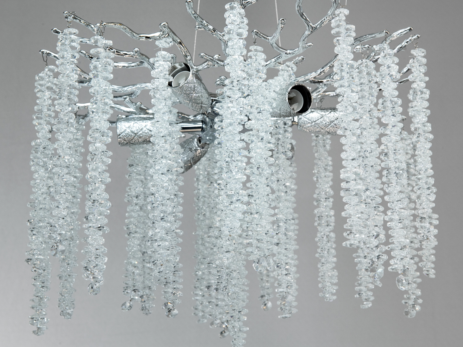 Детальний вигляд люстри з кришталевими підвісками на гіллястій металевій основі. Ідеально підходить для сучасного інтер′єру.