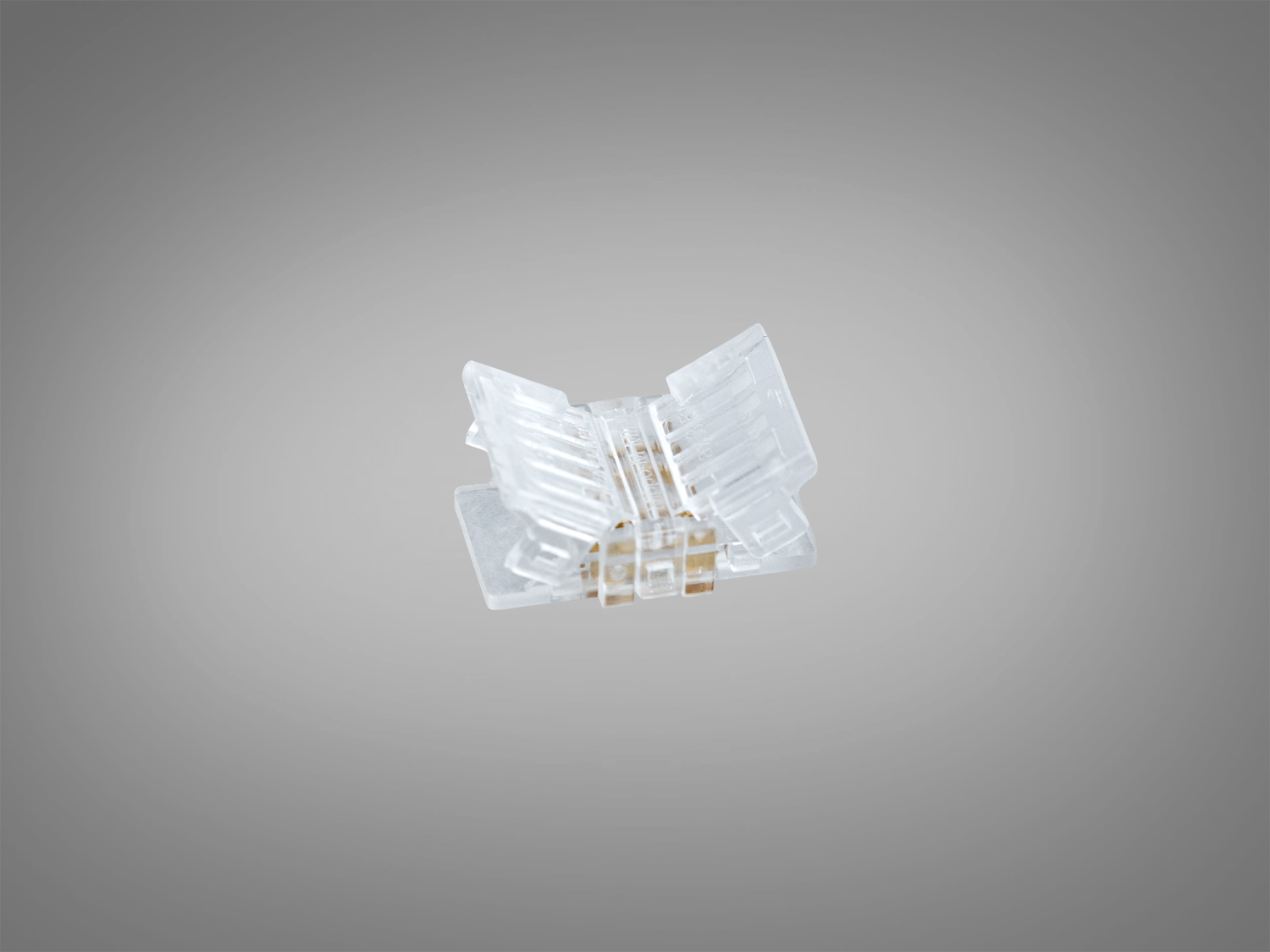 Прозорий пластиковий конектор для світлодіодної стрічки, призначений для швидкого монтажу. Має компактну квадратну форму.