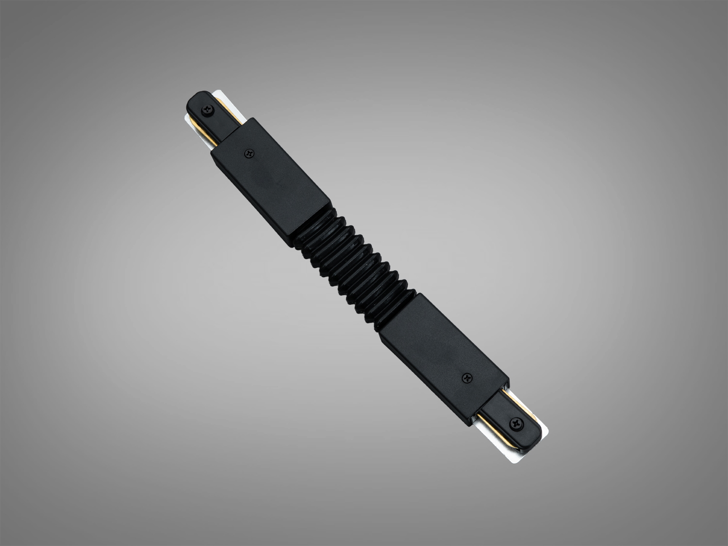 Чорний гнучкий накладний з’єднувач для трекової системи 1209 220 В. Дозволяє формувати повороти та плавні лінії з надійним електроконтактом.