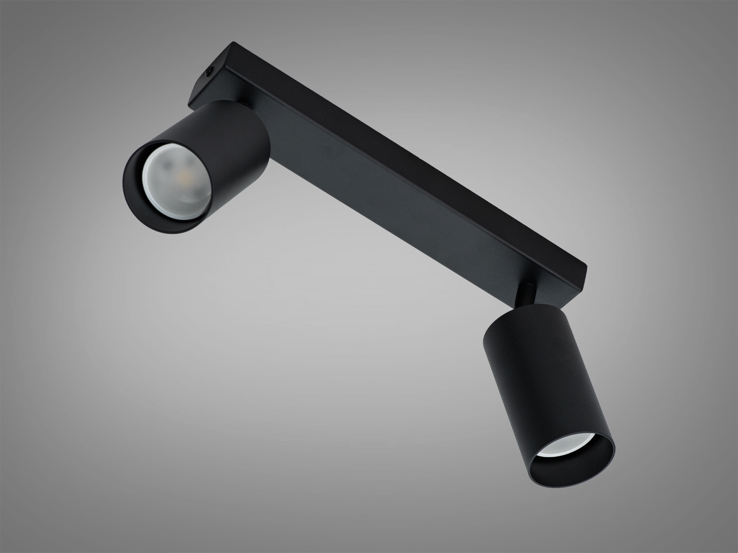 Чорний світильник з двома регульованими лампами, прямокутна основа, підходить для акцентного освітлення в інтер′єрі.